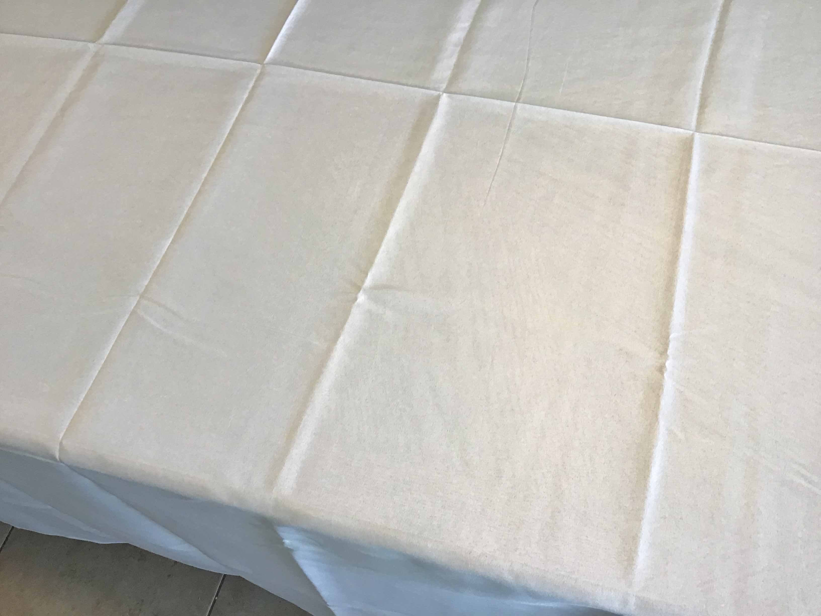 wrinkled tablecloth, fresh out of its original packaging on a table