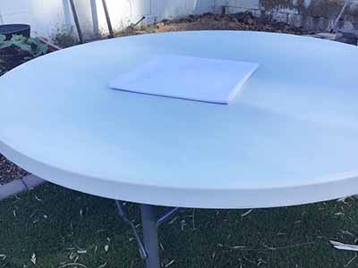 60 inch x 126 inch white rectangle tablecloths pulled directly from storage tote and put onto eight-foot rectangle tables